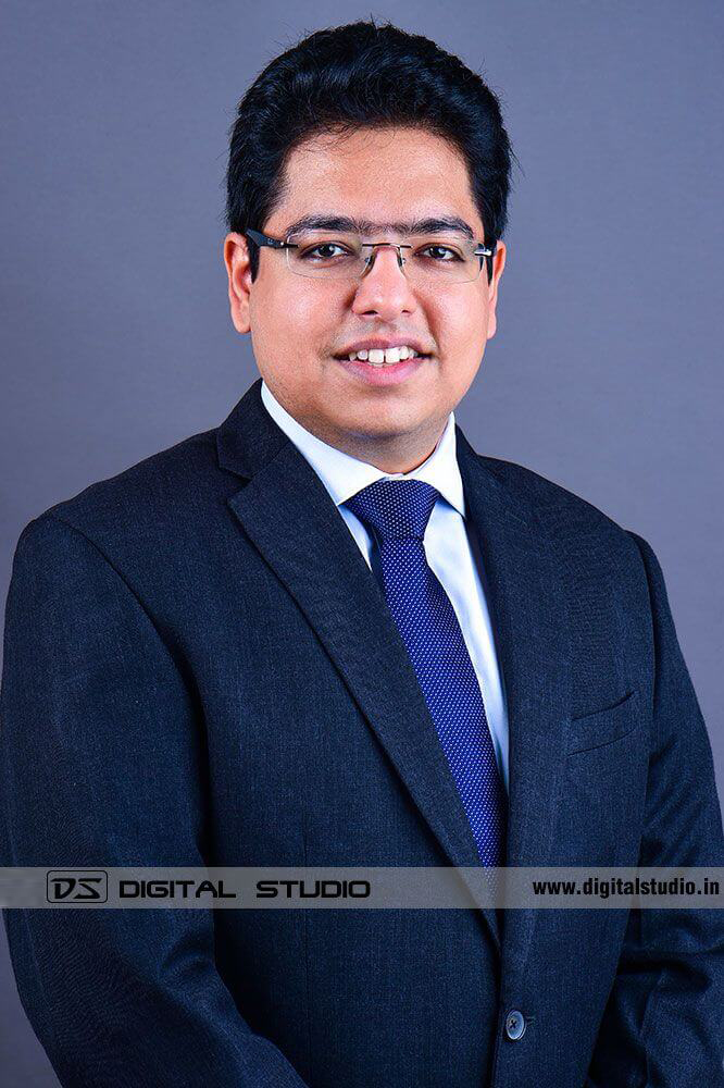 Male corporate headshot withblue backdrop